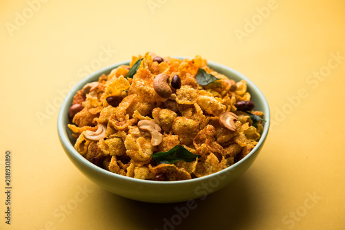 Cornflake Chivda or Corn Chiwda loaded with peanuts and Cashew. Served in a bowl. selective focus