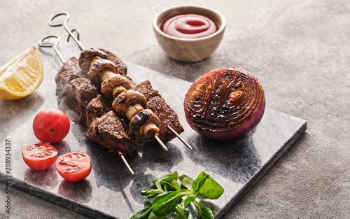 Beef Shish kebab and mushrooms, cherry tomato and ketchup Grilled meat skewers. BBQ lanch