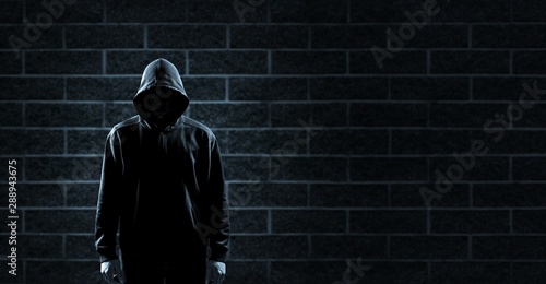 Thief in black clothes on grey background