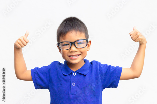 Happy Asian child boy showing thumbs up. On a white background.