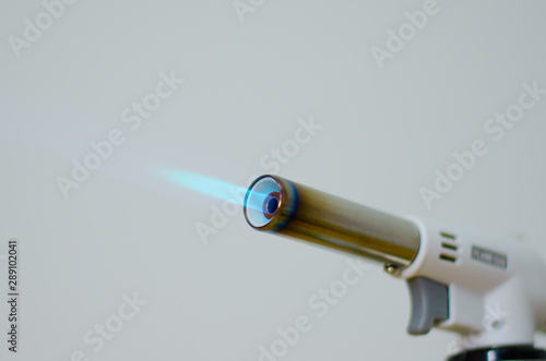 gas flame gun torch blue fire butane white background