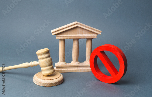 Courthouse with judge's gavel and sign NO. concept of censorship and the production of restrictions and laws on restriction. Anti-popular laws, usurpation of power, conservative views. Lack of justice