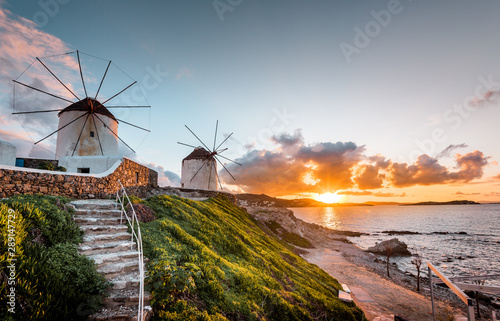 The white windmills of Mykonos Island, famous Mykonos sunset, Kato Mili close to Little Venice, Cyclades, Greece