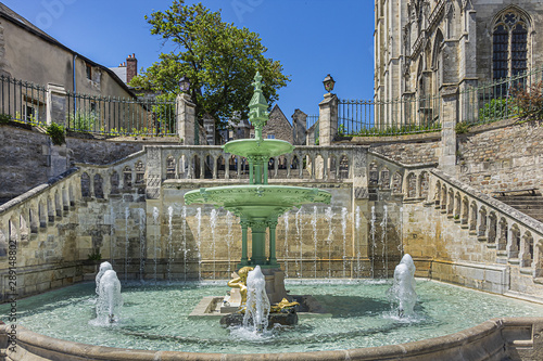 Limestone staircase and fountain date to 1853 near Le Mans Roman Catholic cathedral of Saint Julien (Cathedrale St-Julien du Mans, VI - XIV century). Le Mans, Pays de la Loire region in France.