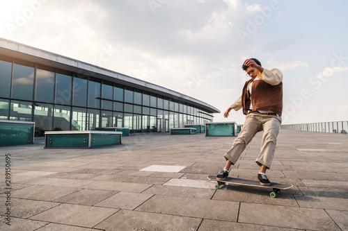 Afro-american man makes turn on his skateboard