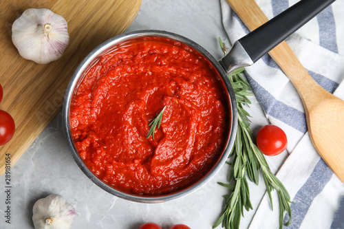 Flat lay composition with delicious tomato sauce on marble table