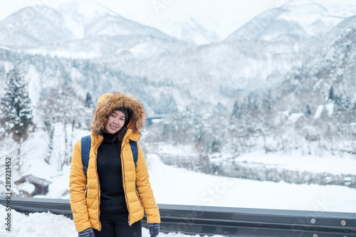 Woman travel in Japan., Winter portrait of young Asian,Beautiful woman in snow. Snowing winter beauty fashion concept at Japan.Woman travel in shirakawago,Japan