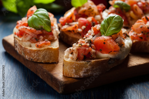 Italian bruschetta with roasted tomatoes, mozzarella cheese and