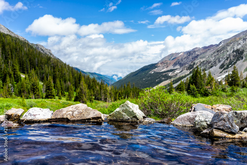 Hot springs blue pool on Conundrum Creek Trail in Aspen, Colorado in 2019 summer with rocks stones and valley view with nobody