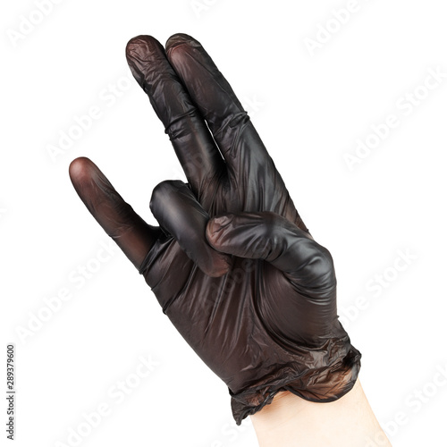 Two In The Pink One In The Stink - hand in black polyethylene glove sexual gesture, isolated on white background