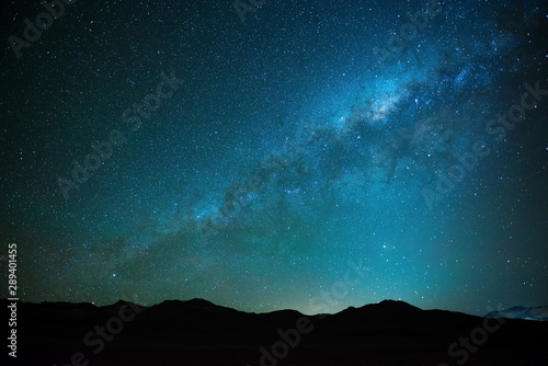 The milky way shining in the Siloli desert at high altitude in the Andes mountain range of Bolivia near Atacama, South America. 