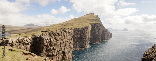 Hike to the Traelanipa Slave Cliff near Leitisvatn Lake with steep drops into the ocean on the Faroe Islands, Denmark.