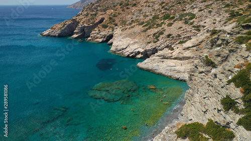 Aerial drone photo of paradise small beach of Mouros with caves and crystal clear sea, Amorgos island, Cyclades, Greece