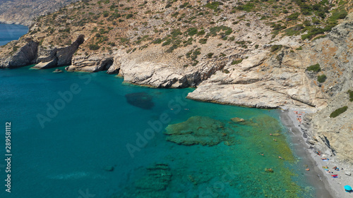 Aerial drone photo of paradise small beach of Mouros with caves and crystal clear sea, Amorgos island, Cyclades, Greece