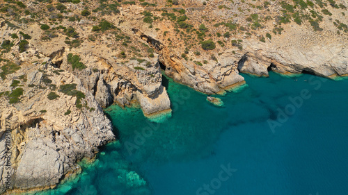 Aerial drone photo of paradise small beach of Mouros with caves and crystal clear sea, Amorgos island, Cyclades, Greece