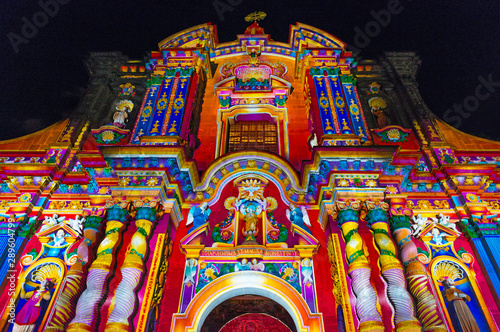 The facade of the Compania de Jesus church illuminated with colorful lights during the light festival, Quito, Ecuador.