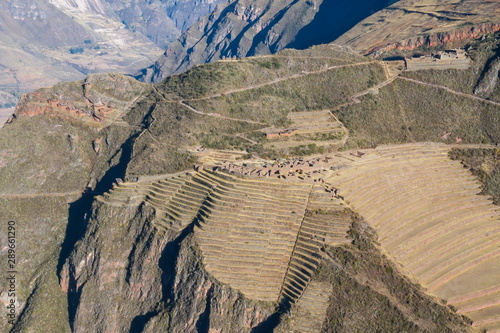 Aerial view of the ancient Inca ruins of Pisac (Pisaq). Archaeological park with green terraces. Sacred Valley near Cusco, Peru. 