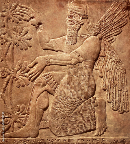 Assyrian relief of god, art of Middle East, Babylonian and Sumerian civilization history