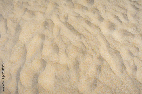 Close up Beach sand in summer sun smooth texture as beautiful background.