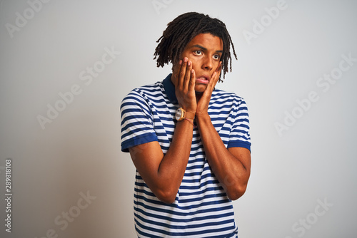 Afro man with dreadlocks wearing striped blue polo standing over isolated white background Tired hands covering face, depression and sadness, upset and irritated for problem