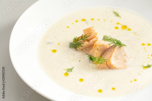 Finnish creamy soup with wild salmon. A bowl of creamy soup with salmon. Healthy food. Close up, selective focus. 