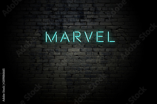 Highlighted brick wall with neon inscription marvel