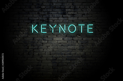 Highlighted brick wall with neon inscription keynote