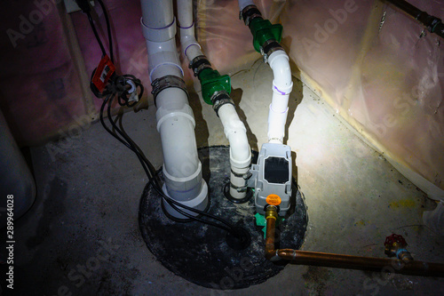 sump pump manhole with water backup viewed with a flashlight