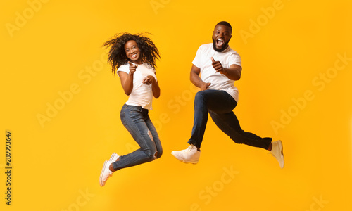 Happy african couple jumping in the air