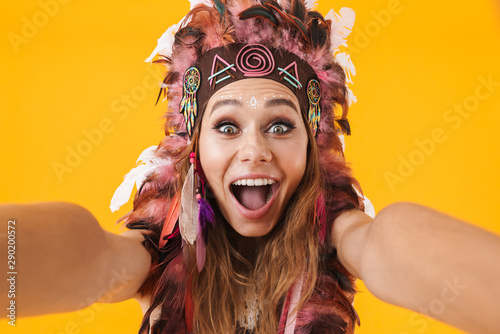Screaming indian woman in carnival suit take selfie by camera.