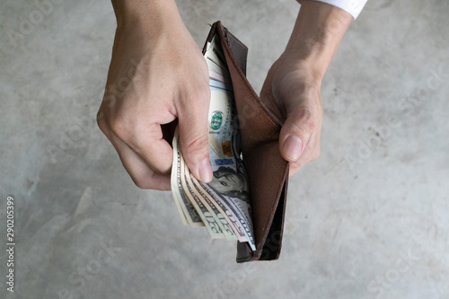 Man holding dollar banknote.young businessman holding money.Business and finances making and saving money concept.