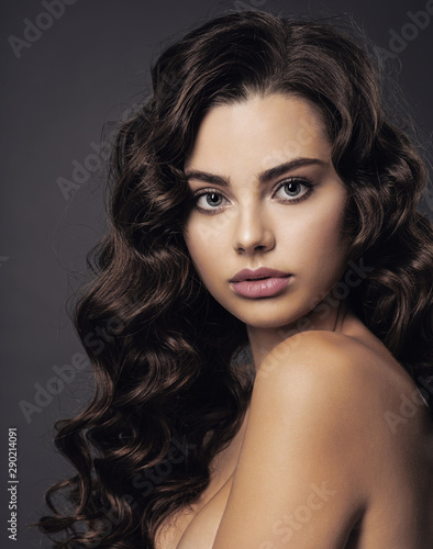 Beautiful young woman with long curly brown hair