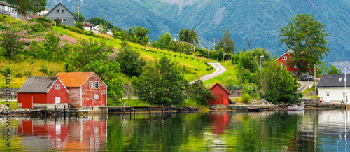 Norwegian rural wooden houses green coast of fjord, landscape sea view, Norway, Rosendal.