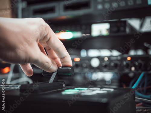 Close up hand on video switcher panel