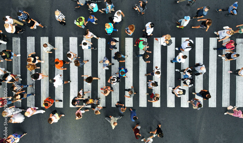 Aerial. Pedestrians on pedestrian crosswalk. Top view.