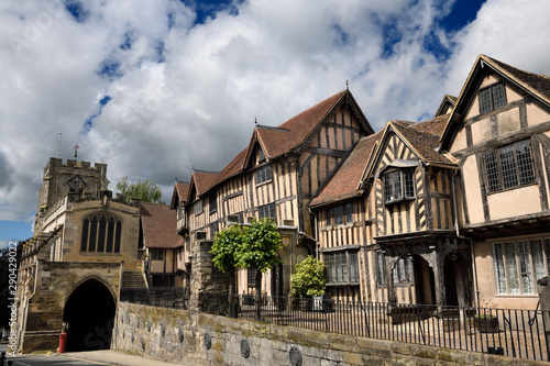 Crooked medieval tudor houses of Lord Leycester Hospital at 12th Century Chapel of St James over West Gate on High Street Warwick England