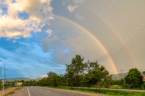 Double rainbow appearing after rain seen from roadside near Lampang province of Thailand