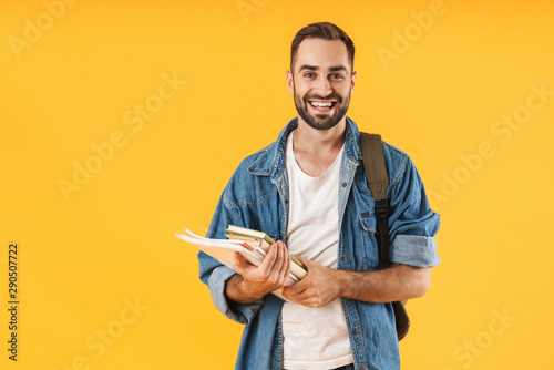 Image of content student guy smiling while holding exercise books