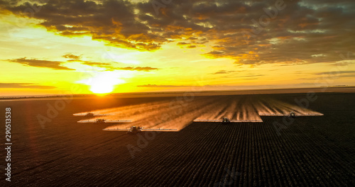 Spraying pesticides and fertilizers on sunset cotton crop