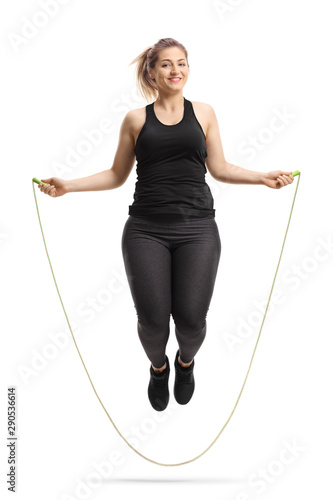 Young cheerful woman skipping a rope