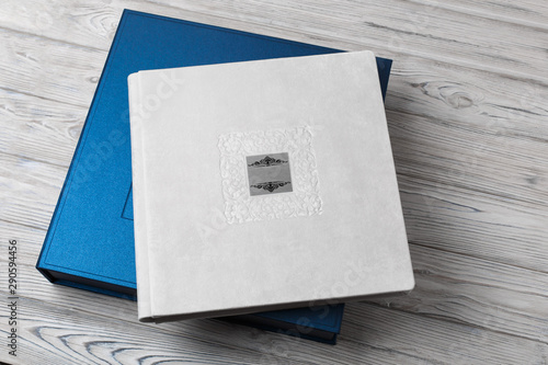 blue stylish square cardboard box for a photo album. Bright original box for white wedding album. leather photo book in the open box blue cardboard box for a photo book