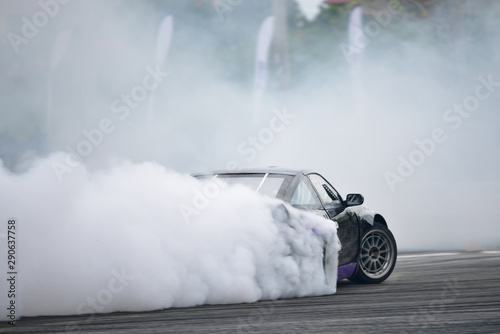 Motion Blur side view drift car. Drift car with smoke from burning tires.