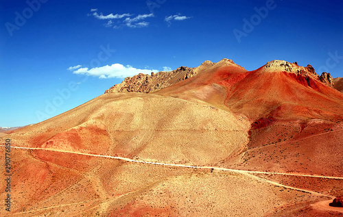 Mountain scenery of Afghanistan near Yakawlang in Bamyan (Bamiyan) Province. These colorful mountains are at the western end of the Hindu Kush mountain range in Central Afghanistan. Orange mountains.