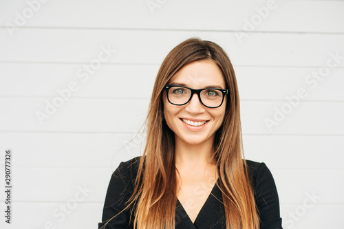 Close up portrait of beautiful young businesswoman wearing eyeglasses
