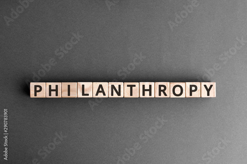 Philanthropy - word from wooden blocks with letters, to help poor people altruism charity philanthropy concept, top view on grey background