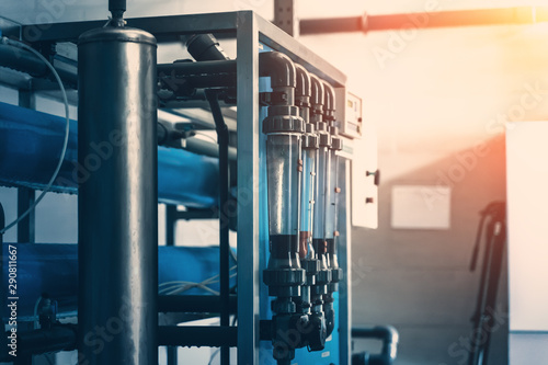 Automatic treatment and multi-level filtration system of drinking water in factory for production of purified drinking water, blue toned with light effect