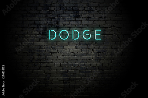 Highlighted brick wall with neon inscription dodge