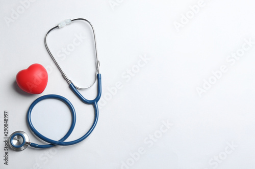 Stethoscope and red heart on white background, top view. Health insurance concept