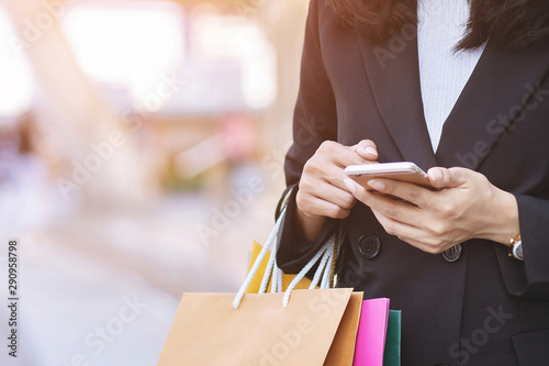 business woman holding hand many shopping bag in fashion boutique to shopping Convenient instant. Customers can use the mobile phone to shopping online Order purchase Sell and Payment transfer money.