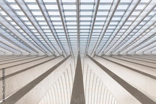 Symmetrical shot of an array of converging marble beams in a modern european trainstation